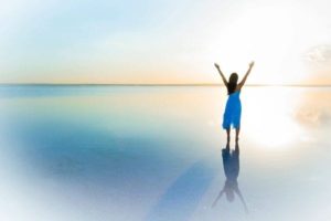 woman holding up sky with sunset